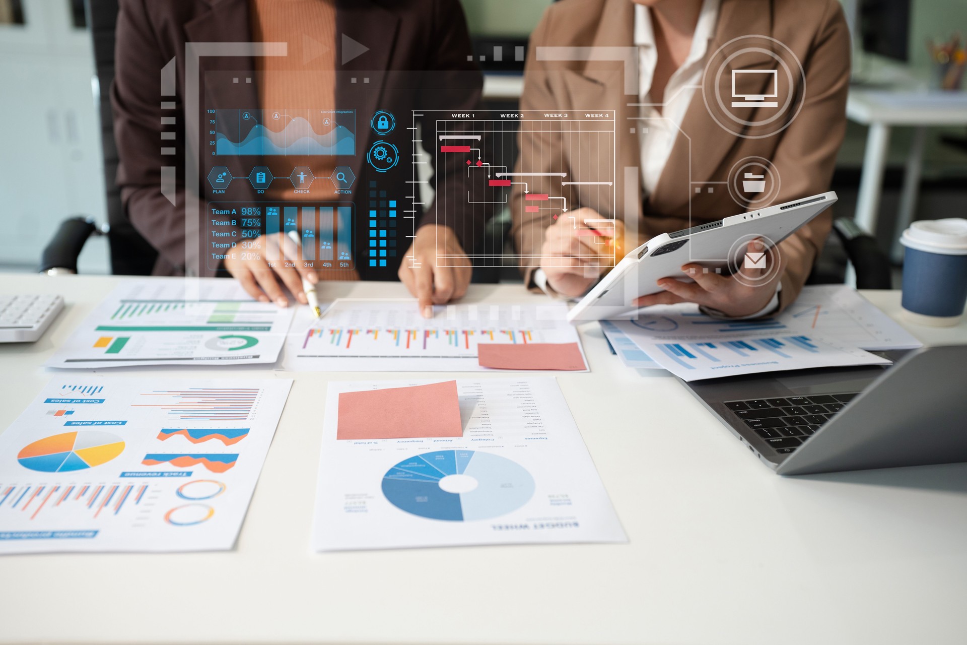 Businessmen team or financial data analysts working with tablets and laptop computers and data graphs together. Plan to analyzing projects in the office.