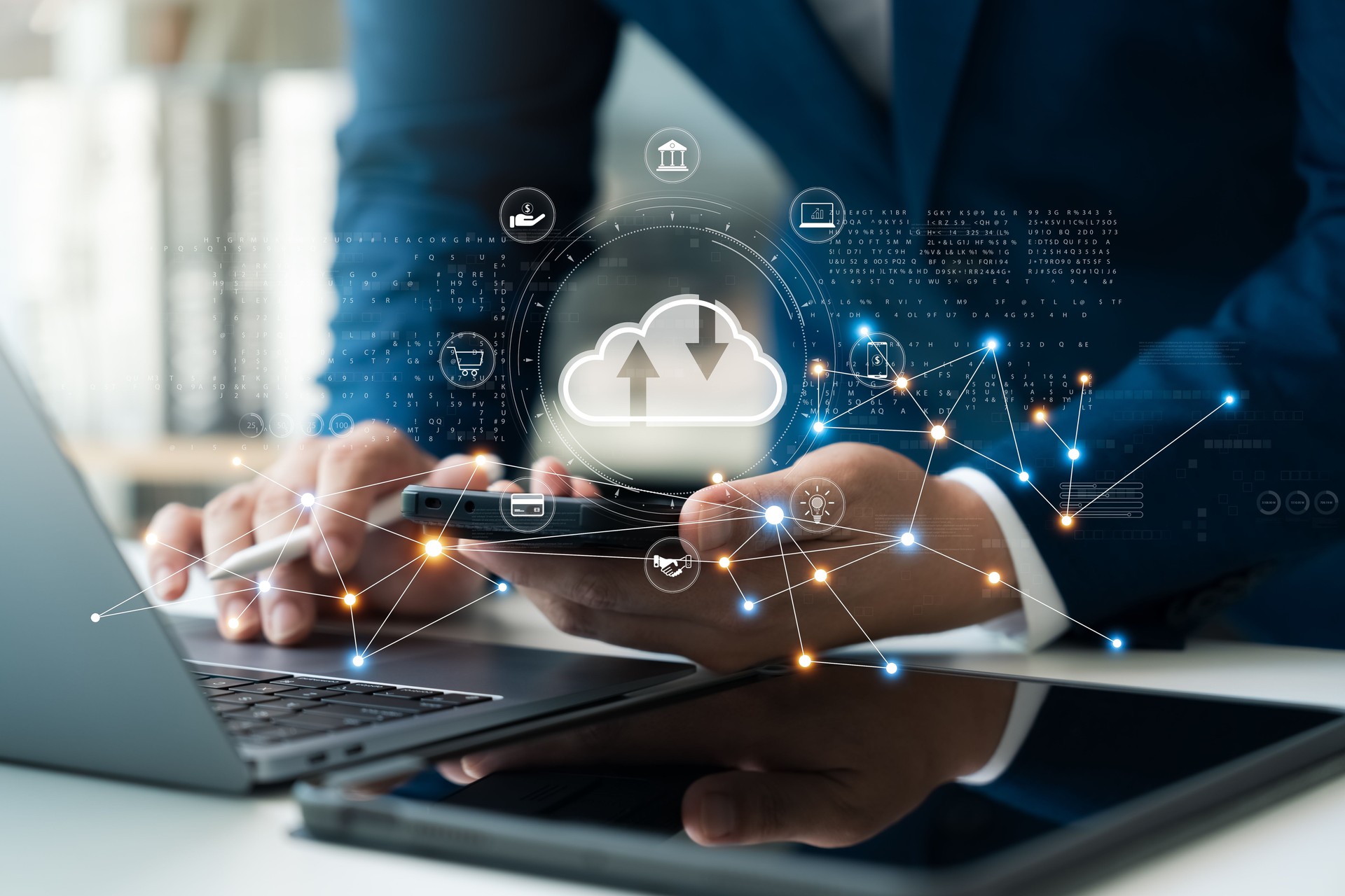 Businessman uses cloud computing technology through laptop and tablet.